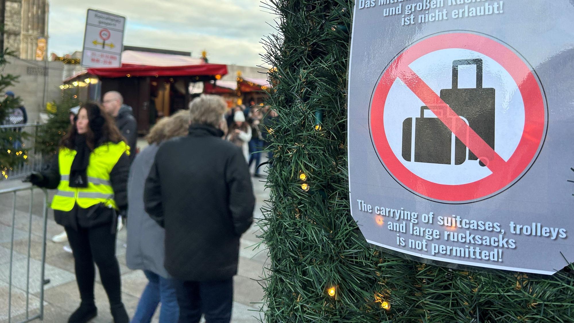 Ein Hinweisschild weist am Roncalliplatz auf das geltende Kofferverbot hin.