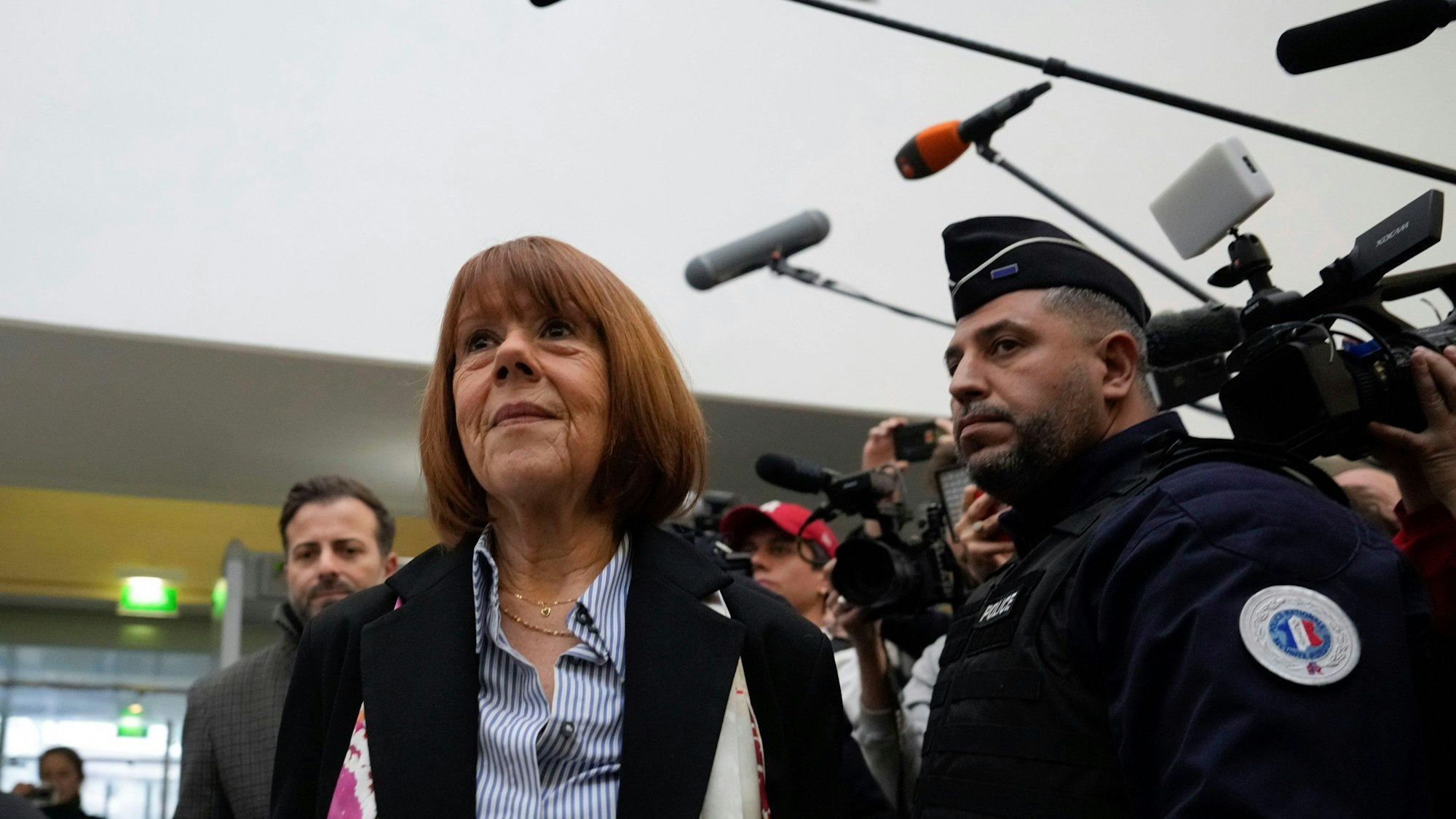 Gisele Pelicot, who was allegedly drugged by her now former husband so that he and others could assault her, arrives at the court house in Avignon, southern France, Thursday, Dec. 19, 2024. (AP Photo/Lewis Joly)