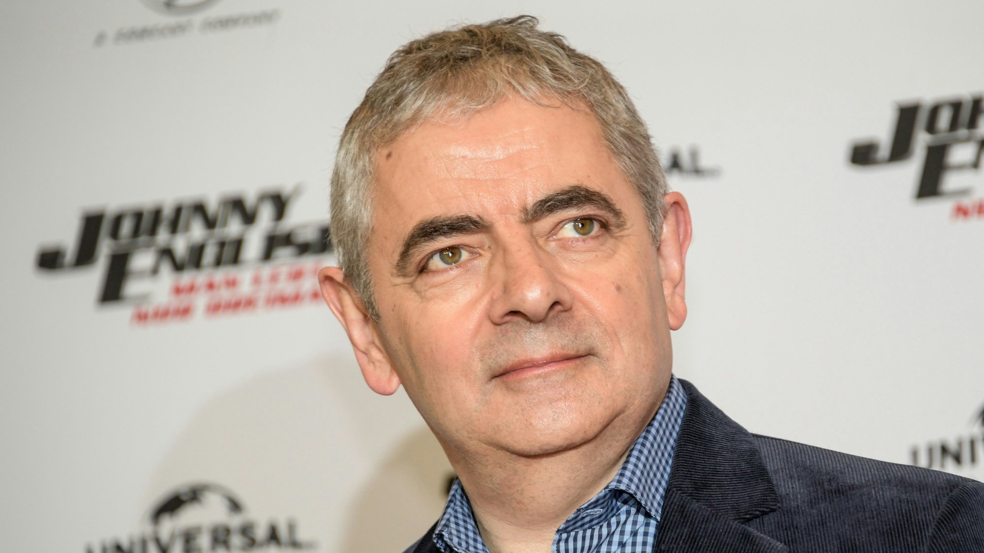 Rowan Atkinson, britischer Schauspieler, steht im Hotel The Fontenay vor einer Wand die den Schriftzug seines neuen Films „Johnny English - Man lebt nur dreimal“ trägt. (Archivbild)