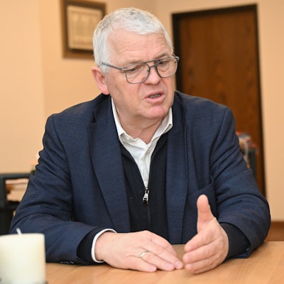 Der Kürtener Bürgermeister Willi Heider sitzt an einem Schreibtisch.