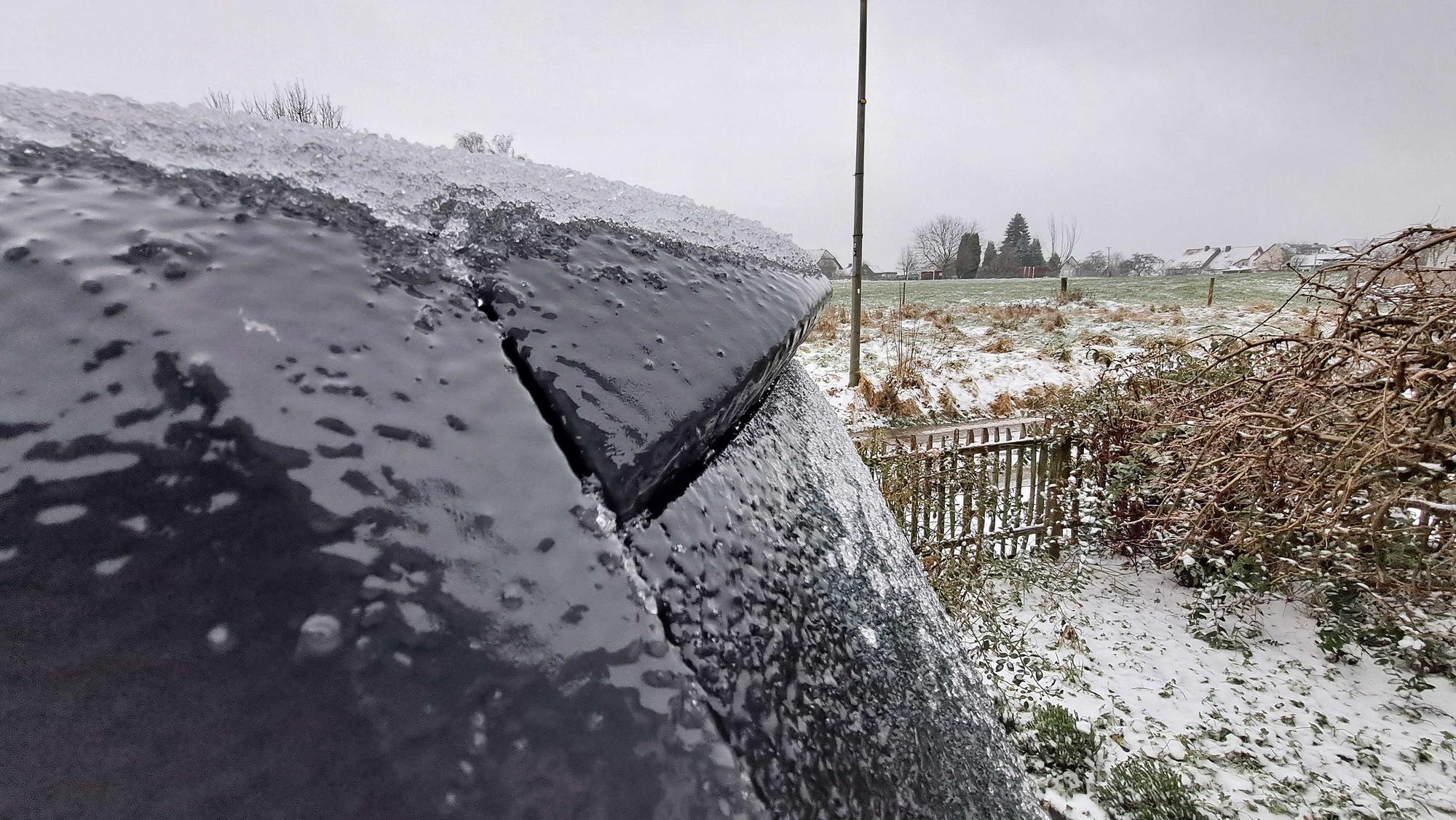 Auch einem Auto ist eine dicke Eisschicht zu sehen.
