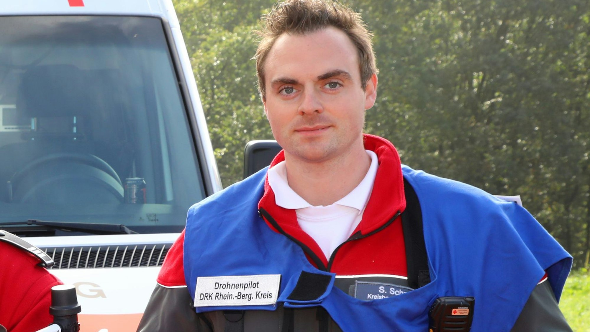Steffen Schmidt steht als Drohnenpilot bei einer Feuerwehrübung in Overath am DRK-Einsatzleitwagen.