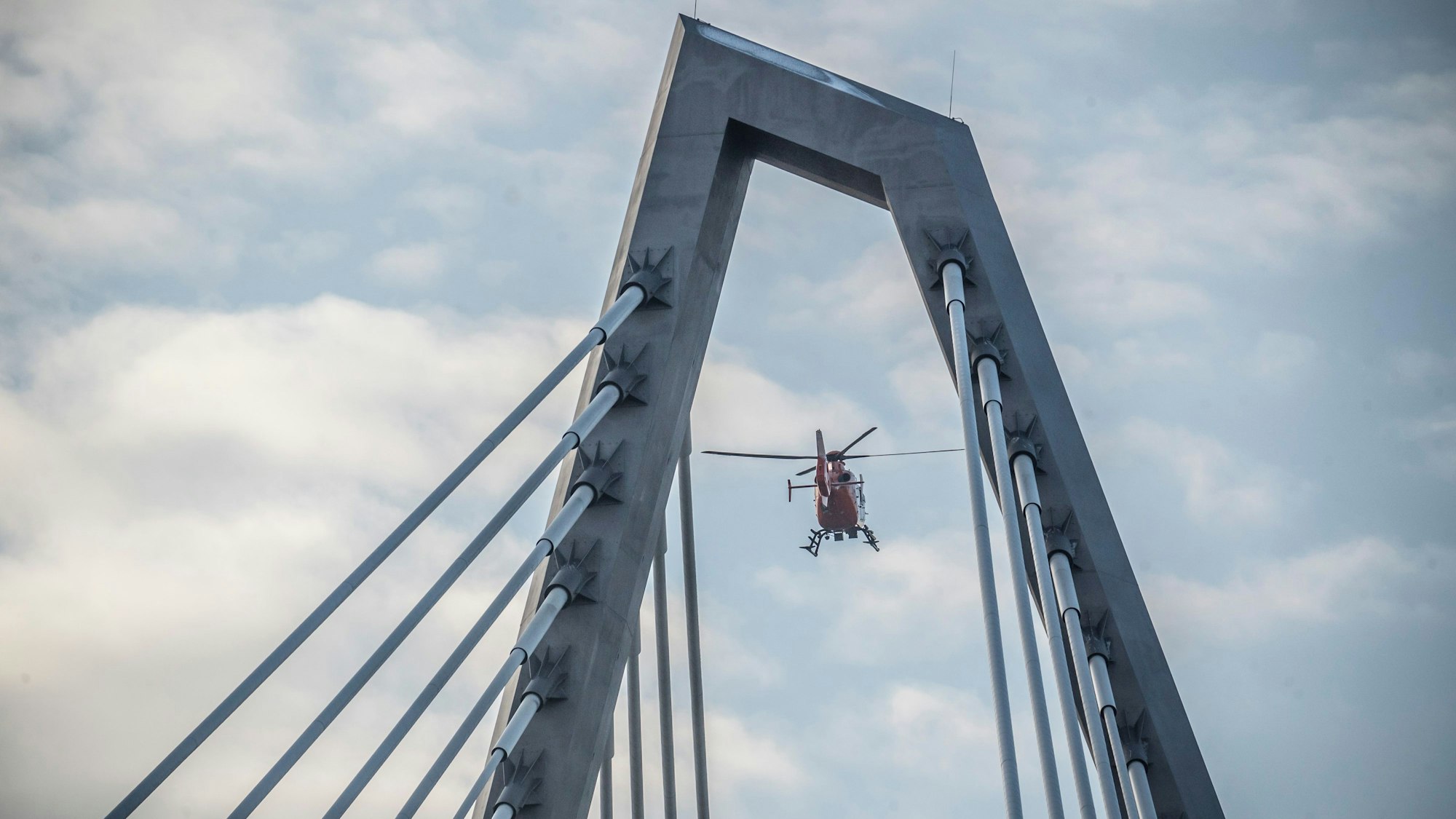 Ein Hubschrauber fliegt über die Leverkusener Brücke.