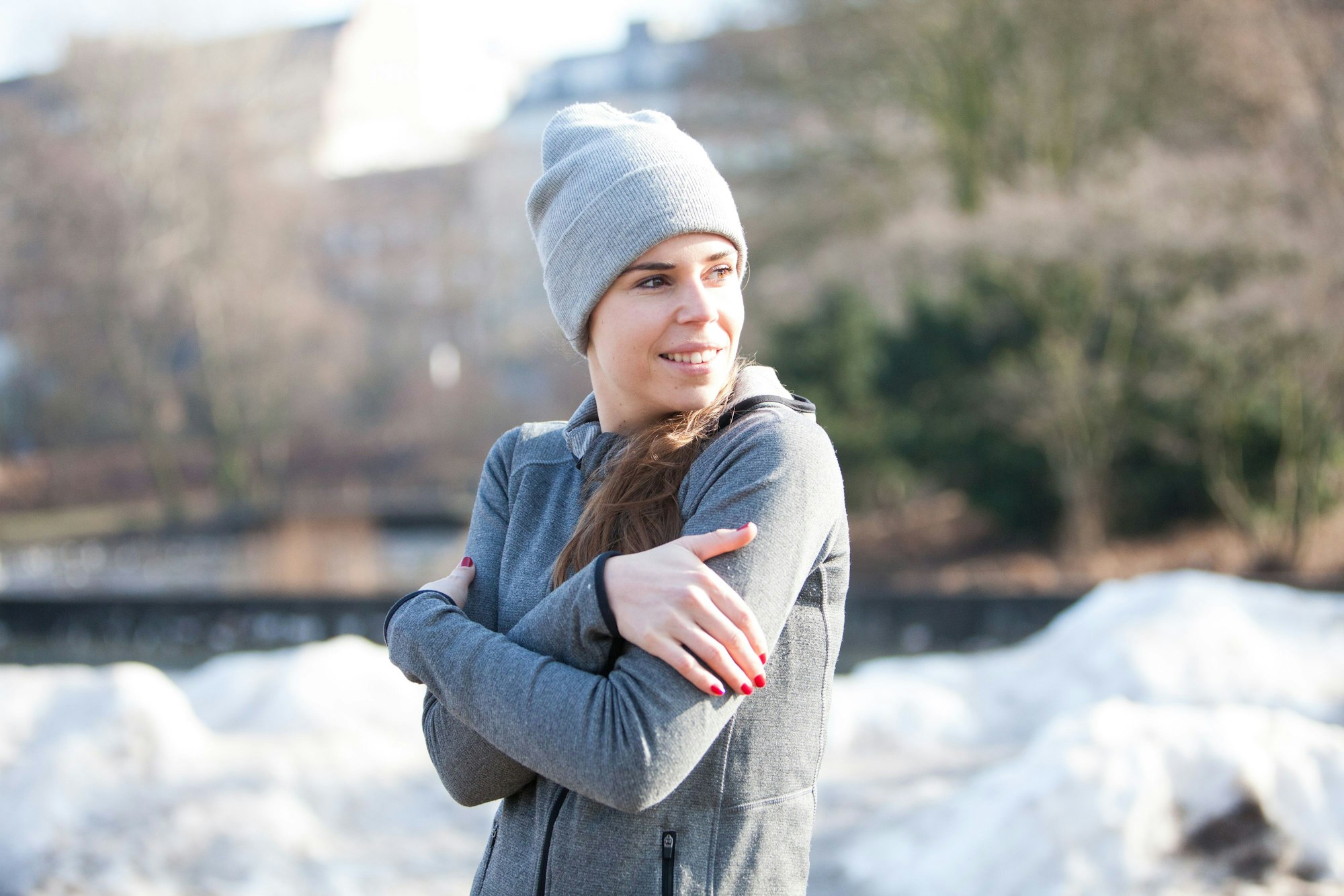 Frau in einem winterlichen Park friert