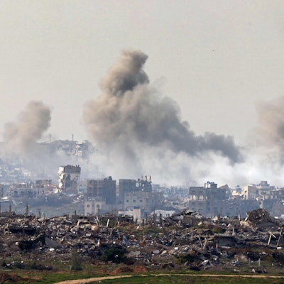 This picture taken from the Israeli side of the border with the Gaza Strip shows smoke plumes rising from explosions above destroyed buildings in the northern Gaza Strip on January 14, 2025, amid the ongoing war between Israel and Hamas. (Photo by Jack GUEZ / AFP)