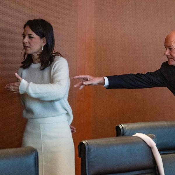TOPSHOT - German Chancellor Olaf Scholz (R) reaches out for German Foreign Minister Annalena Baerbock at the start of the weekly cabinet meeting at the Chancellery in Berlin on January 15, 2025. (Photo by John MACDOUGALL / AFP)