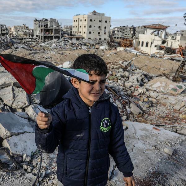 Ein vertriebener palästinensischer Junge, der eine Fahne schwenkt, steht auf Trümmern von Gebäuden, einen Tag nach Inkrafttreten eines Abkommens über eine Waffenruhe zwischen Israel und der Hamas im Gazastreifen.