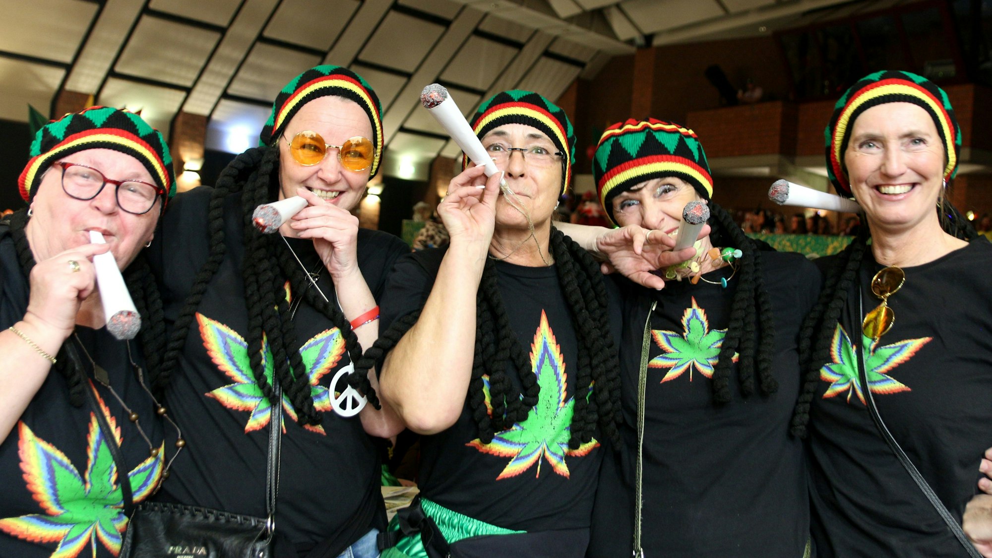Fünf Frauen sind als Rastafari verkleidet, mit großen unechten Joints.