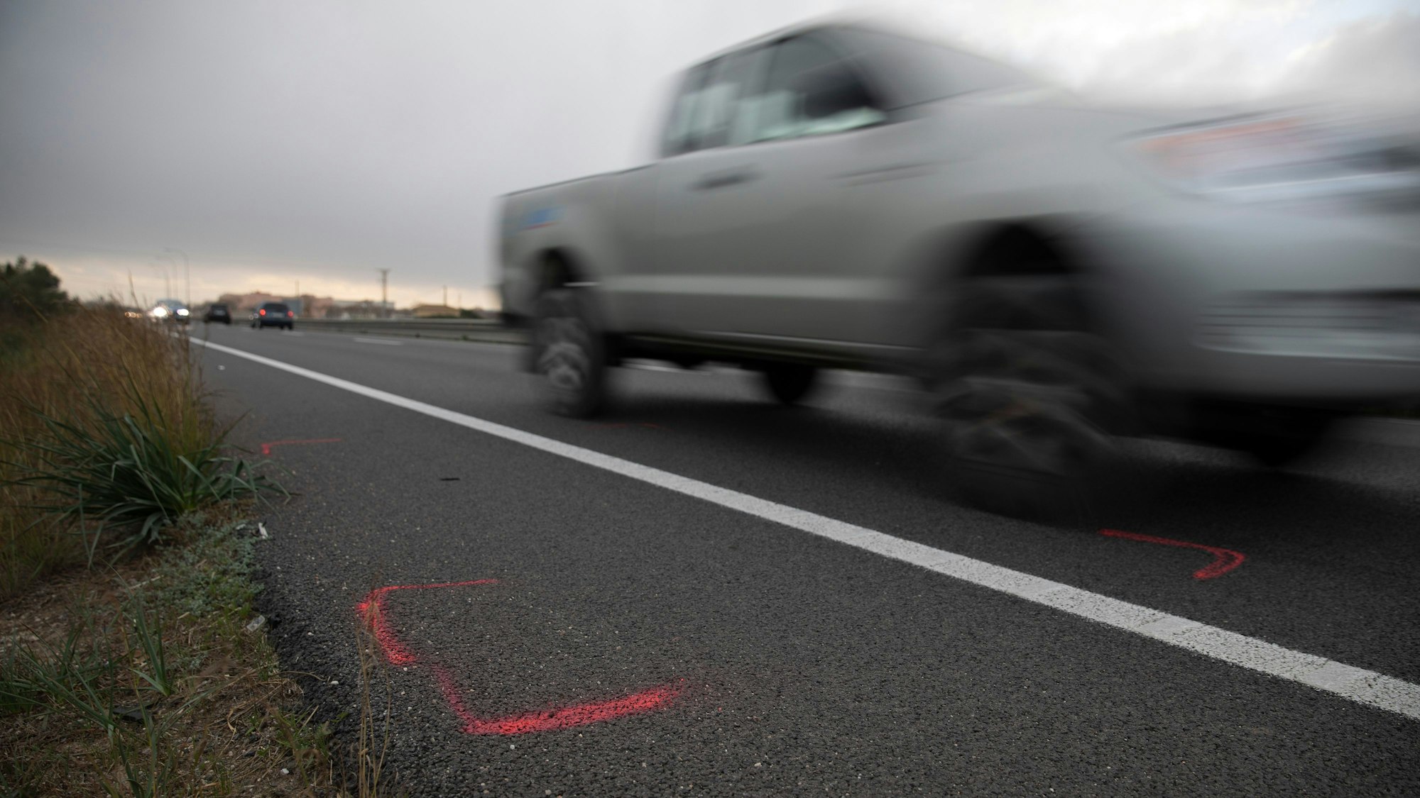 Markierungen sind auf der Straße auf Mallorca zu sehen, nachdem sich hier am Vormittag der schwere Unfall ereignet hatte.