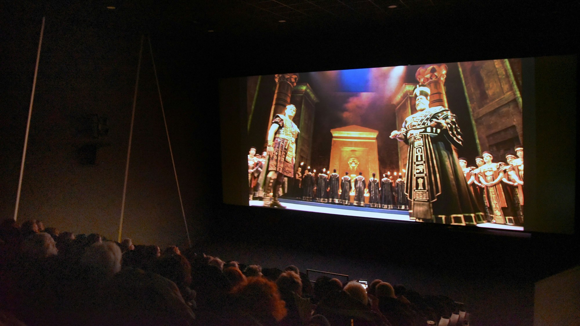 Ein Kinosaal, auf der Leinwand eine Szene aus der Oper „Aida“.