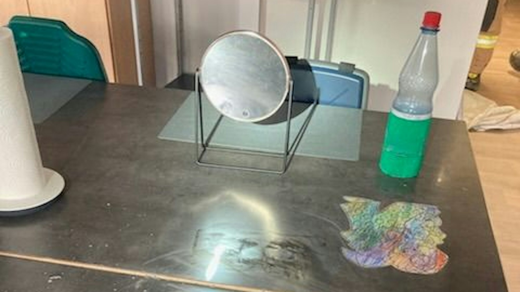 Ein Spiegel steht auf einem Arbeitstisch.