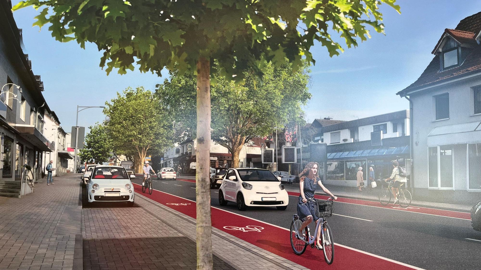 Auf einem Radstreifen fährt eine Fahrradfahrerin.