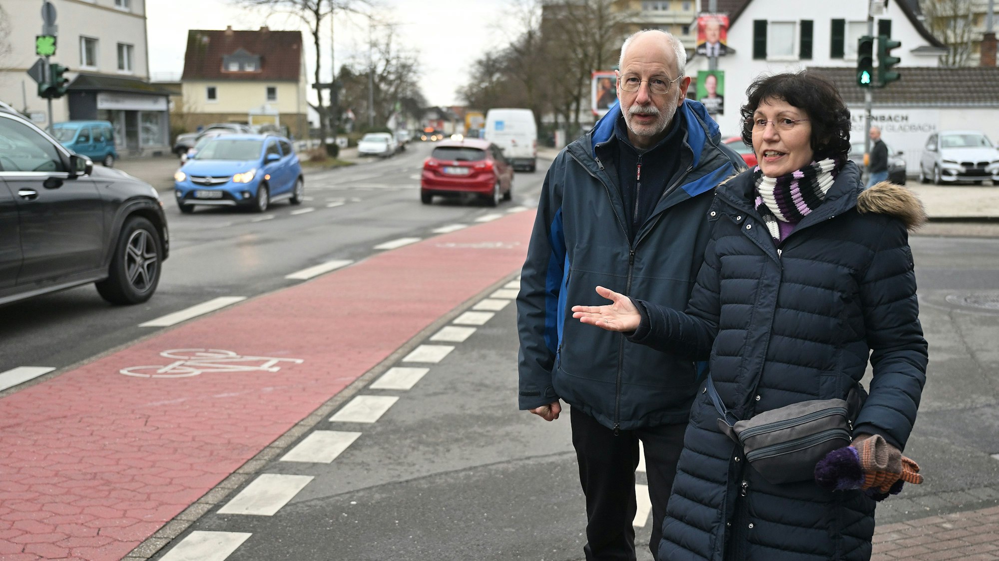 Das Ehepaar steht an der Straße neben einem Radweg.