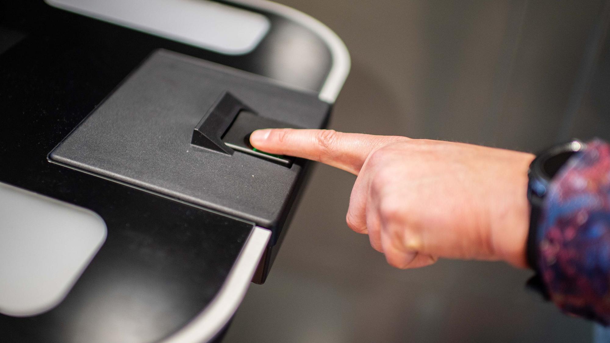 Das Bild zeigt eine Männerhand, die den linken Zeigefinger auf einen Sensor gelegt hat.