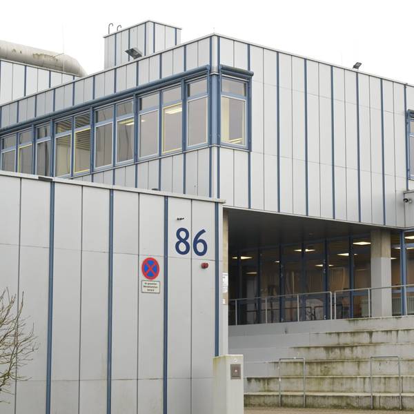 Man sieht die grauen Fassaden des Eingangsbereichs der Schule.