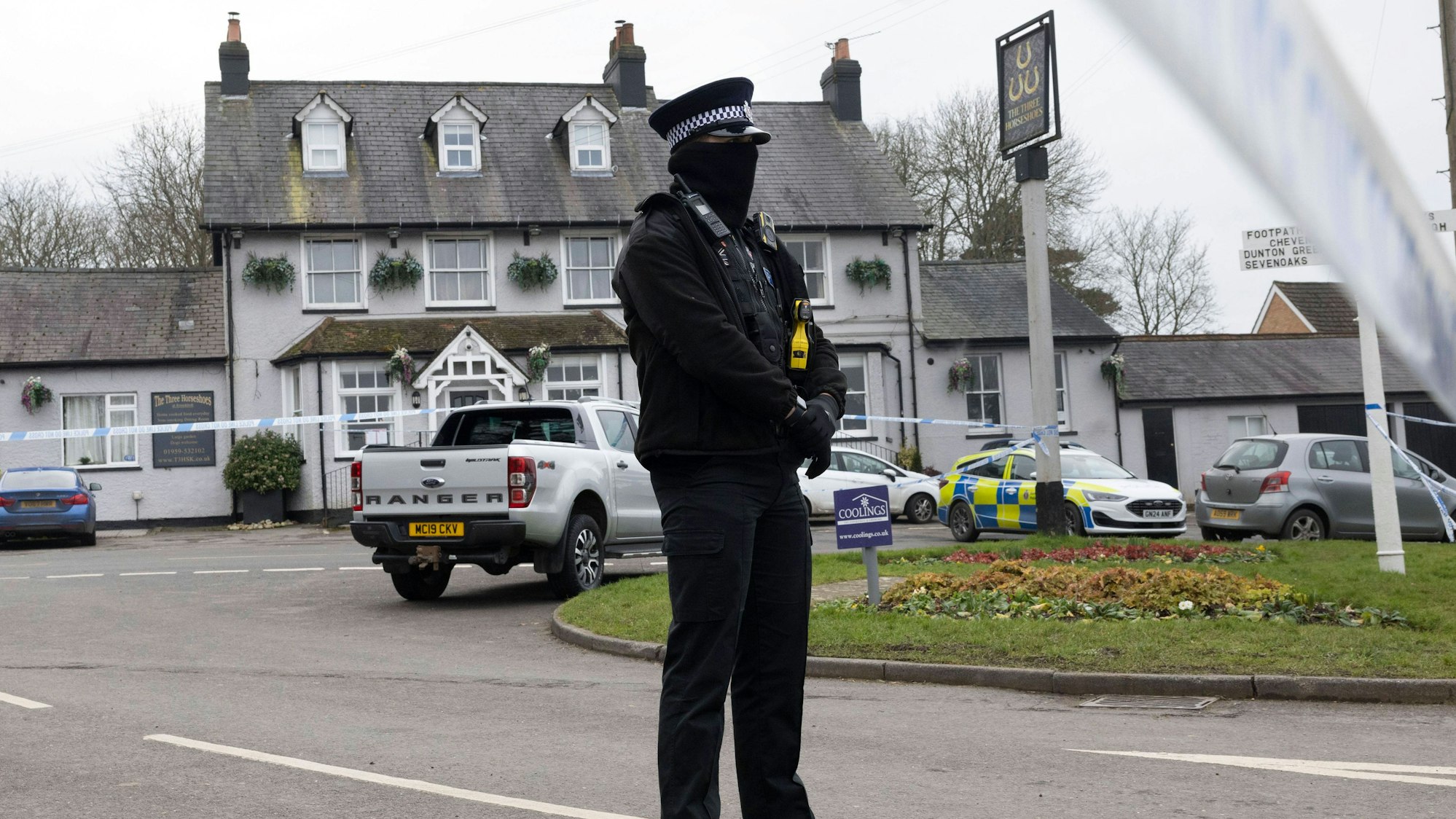 Ein Polizist am Tatort einer mutmaßlichen Schießerei vor dem The Three Horseshoes Pub in Knockholt, Kent, Vereinigtes Königreich.