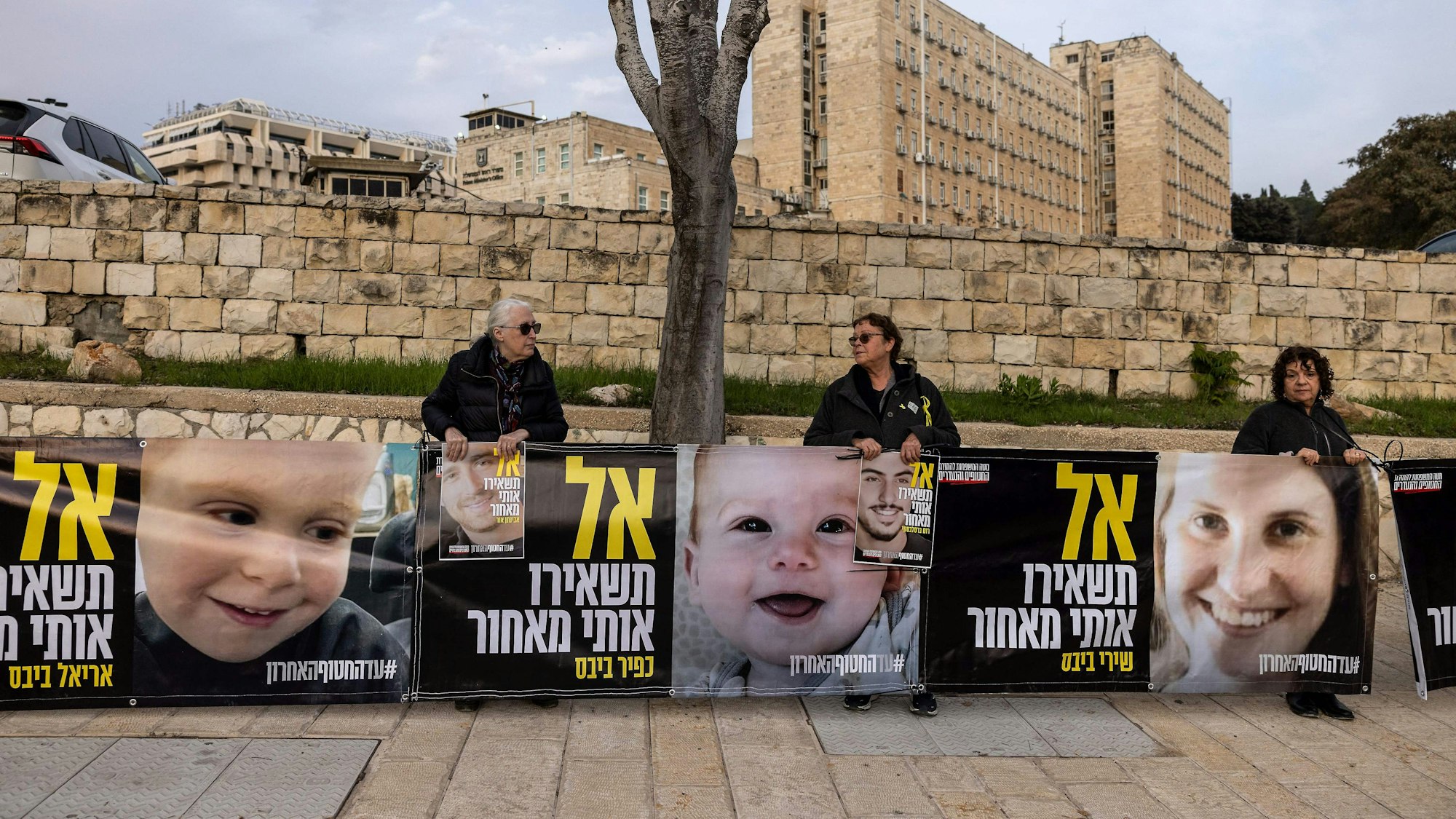 Supporters and relatives of Israeli hostages held captive in the Gaza Strip since the Oct. 7, 2023 attacks by Palestinian militants hold images of the Bibas family as they protest in front of the prime minister's office in Jerusalem on February 3, 2025, calling to complete the deal with Hamas and to bring all hostages back. Israeli Prime Minister Benjamin Netanyahu will begin talks on a second phase to the Gaza ceasefire in Washington on February 3, his office said hours after the completion of the fourth hostage-prisoner exchange of the truce. (Photo by Menahem Kahana / AFP)