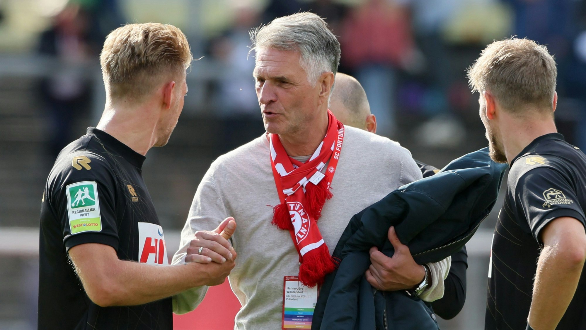 Präsident Hanns-Jörg Westendorf (M.) zeigt sich erfreut über den Sieg gegen Gladbach.
