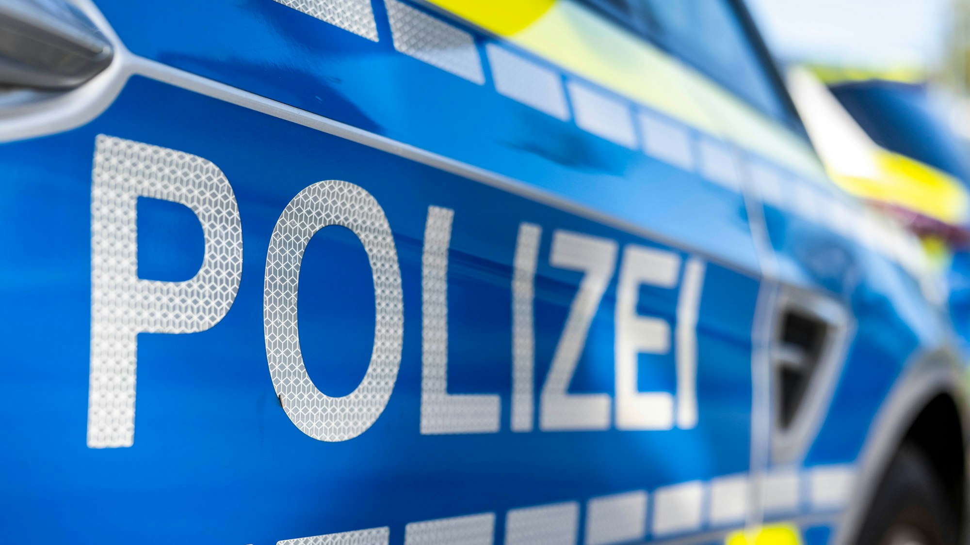 An der Tür von einem Streifenwagen steht der Schriftzug «Polizei».