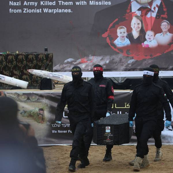 Palestinian militants carry one of the four coffins during the handing over of the bodies of four Israeli hostages to the Red Cross in Khan Yunis in the southern Gaza on February 20, 2025. Hamas handed over on February 20 coffins believed to contain the bodies of four Israeli hostages, including those of the Bibas family who became symbols of the ordeal that has gripped Israel since the Gaza war began. The transfer of the bodies is the first by Hamas since its October 7, 2023 attack on Israel triggered the war, and is taking place under a fragile ceasefire that has seen living hostages exchanged for Palestinians held in Israeli prisons. (Photo by Eyad BABA / AFP)