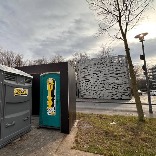 Mobile Toilette vor einer Umhausung