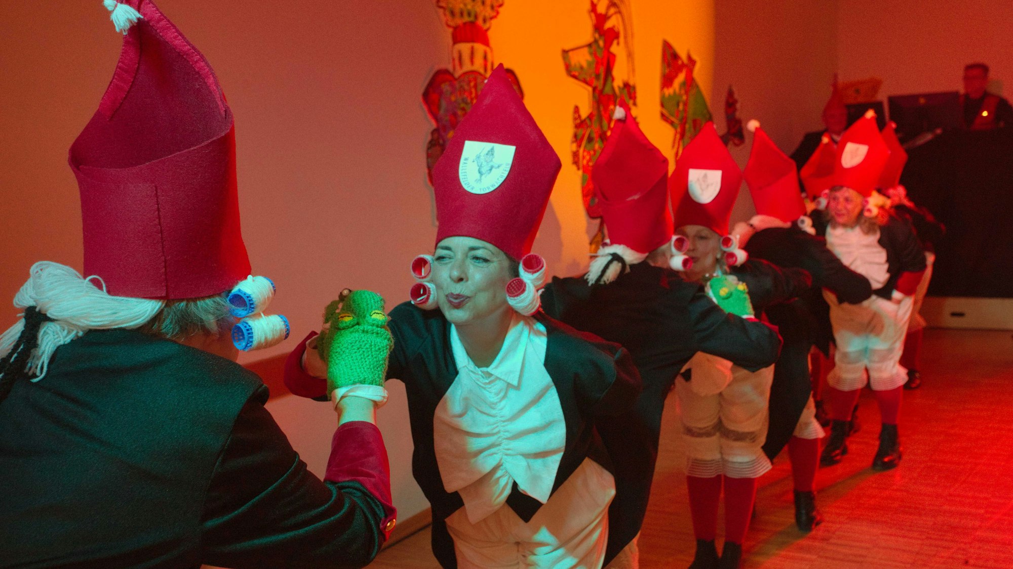 Eine Frauengruppe als Wallefelder Torwachteln verkleidet bei einem Auftritt auf einer Karnevalsbühne.