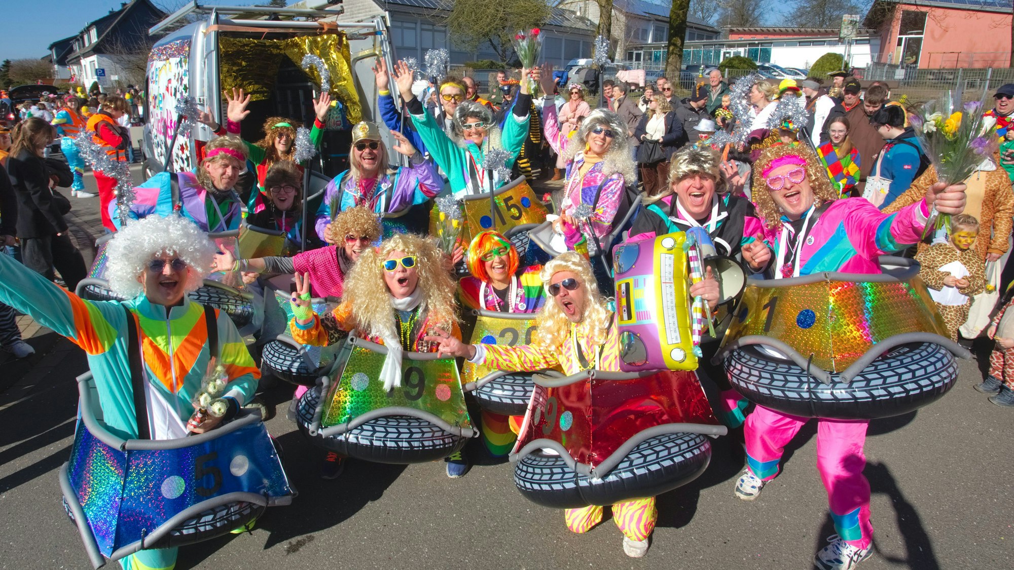 Eine als Autoscooter verkleidete Gruppe bei einem Karnevalszug.