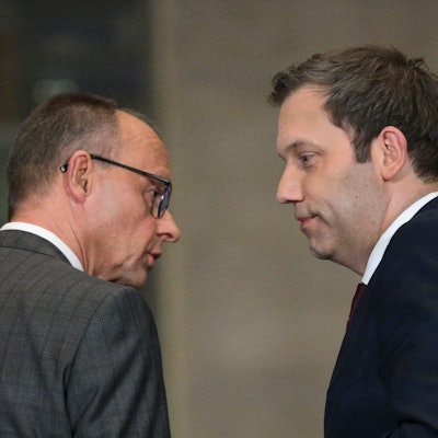 Leader of Germany's Christian Democratic Union (CDU) Friedrich Merz (L) and Germany's Social Democratic Party (SPD) Chairman Lars Klingbeil look at each other as they hold a press conference on planned major investments, in Berlin, on March 4, 2025. Germany's likely next chancellor Friedrich Merz said on March 4, 2025 his centre-right CDU/CSU and the centre-left Social Democrats (SPD) would propose hundreds of billions in extra spending on defence and the economy. (Photo by RALF HIRSCHBERGER / AFP)