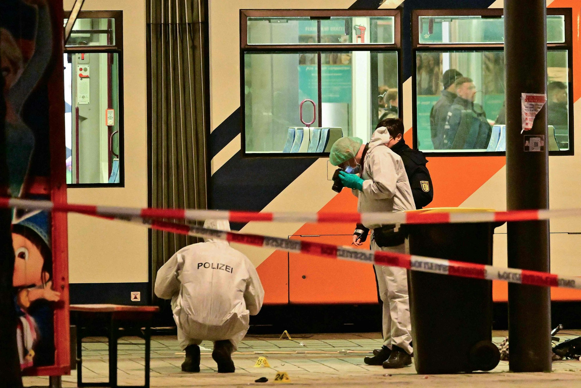 TOPSHOT - Police investigators work at the scene of car ramming attack in Mannheim, southwestern Germany on March 3, 2025. A car driven into a crowd in southwest Germany on Monday killed two people, authorities said, adding they had arrested a 40-year-old German man after the incident. (Photo by Thomas LOHNES / AFP) / ALTERNATIVE CROP