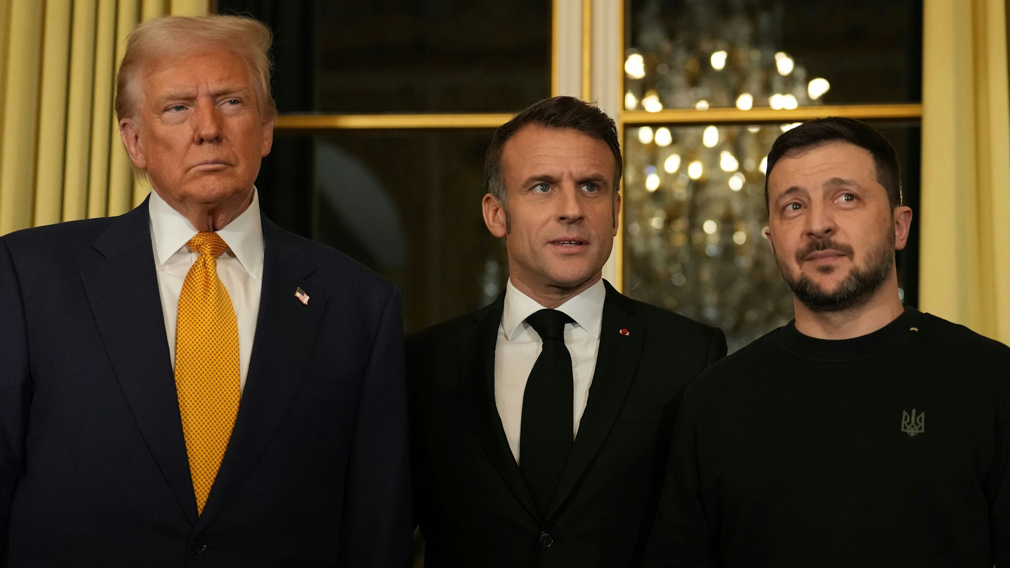 Emmanuel Macron (M) posiert mit US-Präsident Donald Trump (l.) und dem ukrainischen Präsidenten Wolodymyr Selenskyj im Elysee-Palast. (Archivbild)