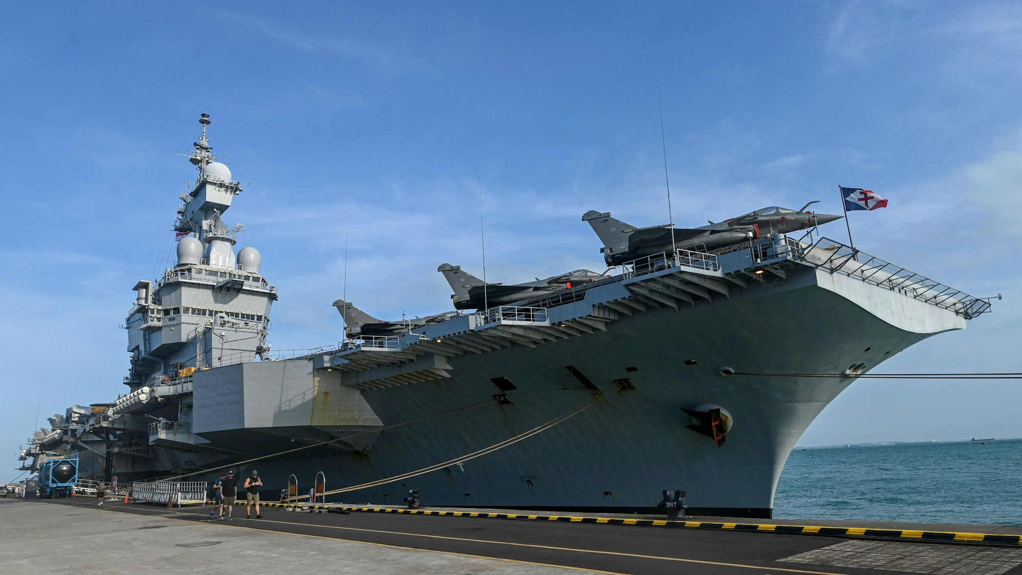 French Rafale Marine fighter jets are seen on the flight deck of the French aircraft carrier Charles de Gaulle during a media tour at Changi Naval Base in Singapore on March 4, 2025. (Photo by Roslan RAHMAN / AFP)