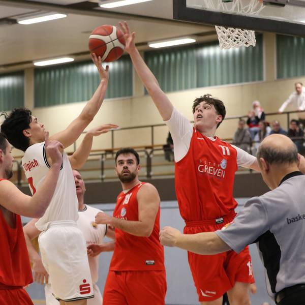 Zwei Basketballspieler steigen zum Ball hoch und versuchen ihn zu bekommen.