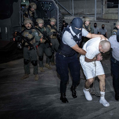 This handout picture released on March 16, 2025, by El Salvador's Presidency press office shows the arrival of alleged members of the Venezuelan criminal organization Tren de Aragua at the Terrorism Confinement Center (CECOT) in the city of Tecoluca, El Salvador. The United States has sent over 200 alleged members of a Venezuelan gang to be imprisoned in El Salvador, President Nayib Bukele said Sunday, after US counterpart Donald Trump invoked wartime authorities to expel migrants. (Photo by Handout / EL SALVADOR'S PRESIDENCY PRESS OFFICE / AFP) / RESTRICTED TO EDITORIAL USE - MANDATORY CREDIT "AFP PHOTO / EL SALVADOR'S PRESIDENCY PRESS OFFICE" - NO MARKETING NO ADVERTISING CAMPAIGNS - DISTRIBUTED AS A SERVICE TO CLIENTS