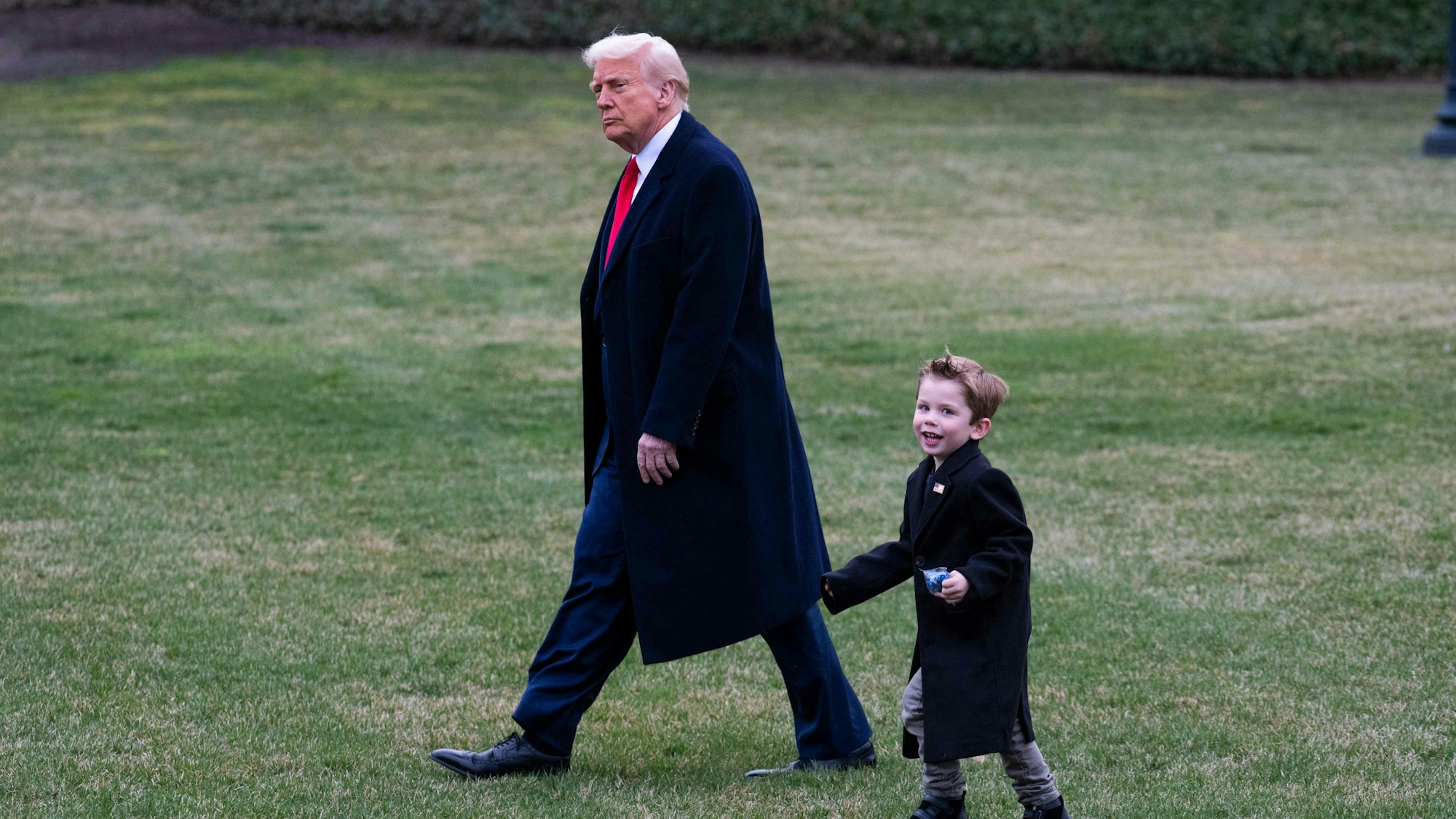 US President Donald Trump walks with Elon Musks son X Æ A-12 before boarding Marine One at the South Lawn of the White House in Washington, DC on March 14, 2025. Trump is spending the weekend at his Florida Mar-a-Lago resort. (Photo by ROBERTO SCHMIDT / AFP)