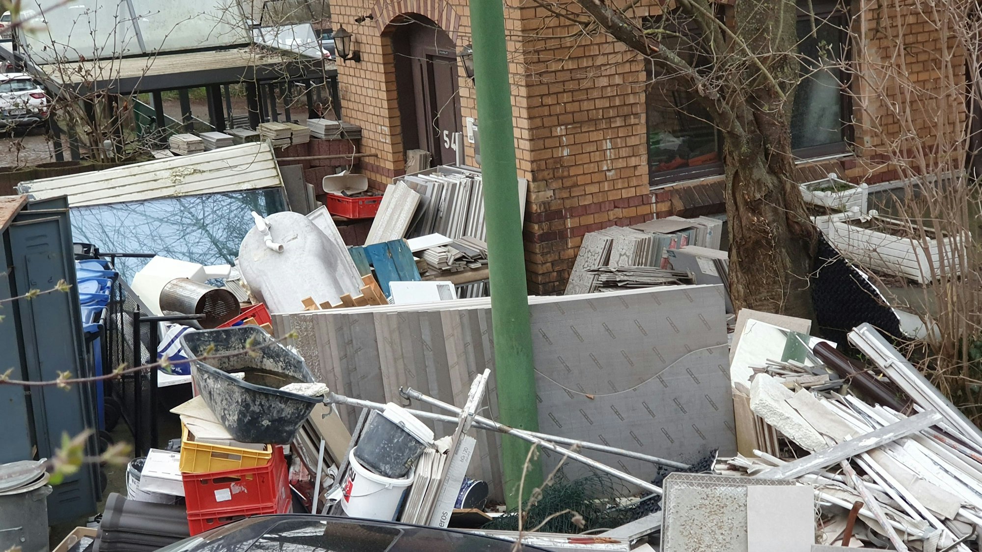 Auf dem Bild ist ein denkmalgeschütztes Gebäude, vor dem Müllhaufen lagern, zu sehen.