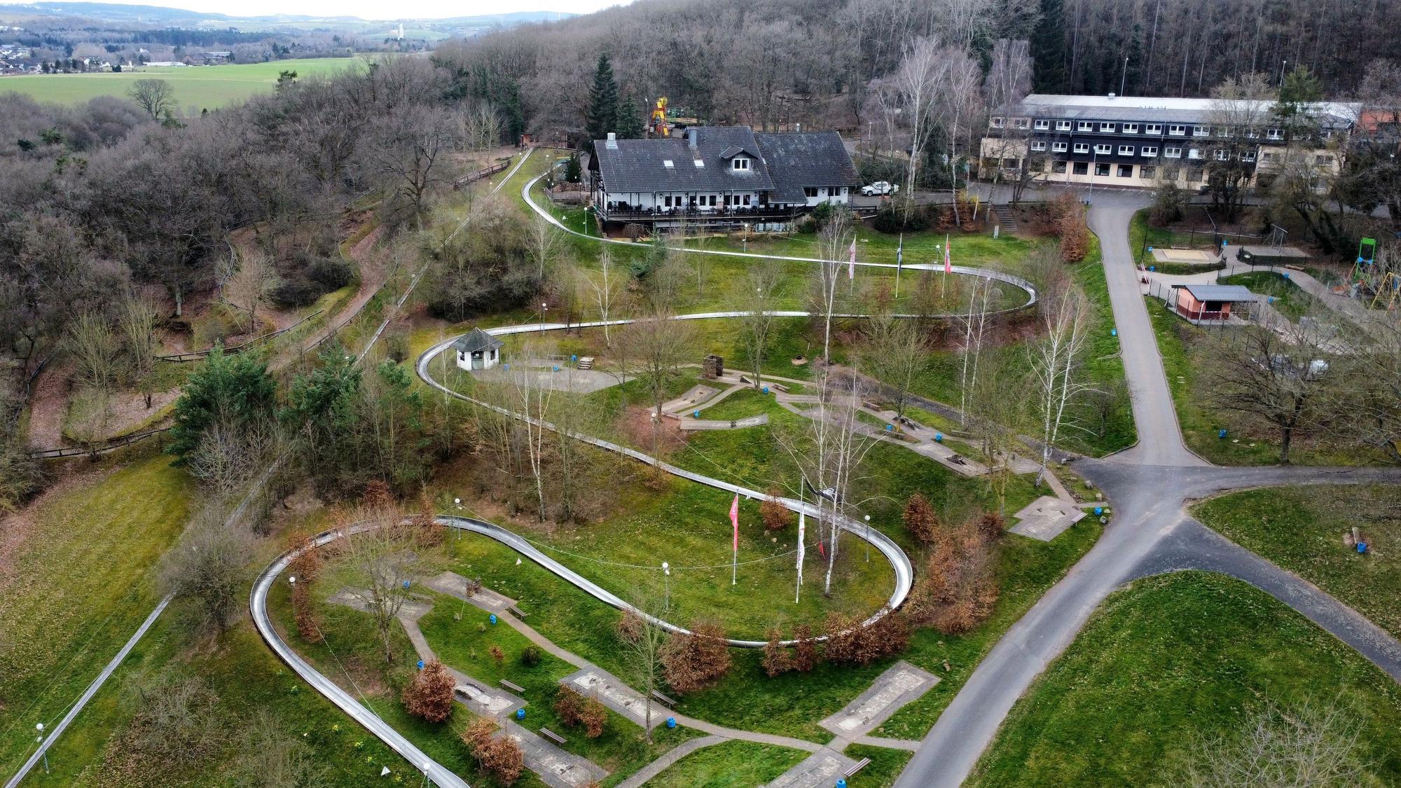 Die Erlebniswelt Eifeltor mit Sommerrodelbahn, Hotel- und Gastronomiegebäuden in Mechernich-Kommern (Drohnenaufnahme).