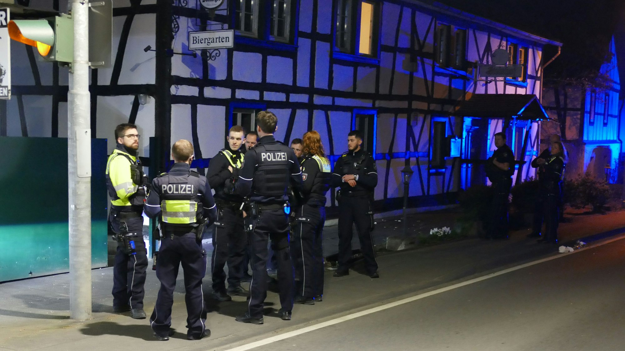 Polizistinnen und Polizisten stehen vor dem Steinhof an der L333, wo der Tatverdächtige festgenommen wurde.