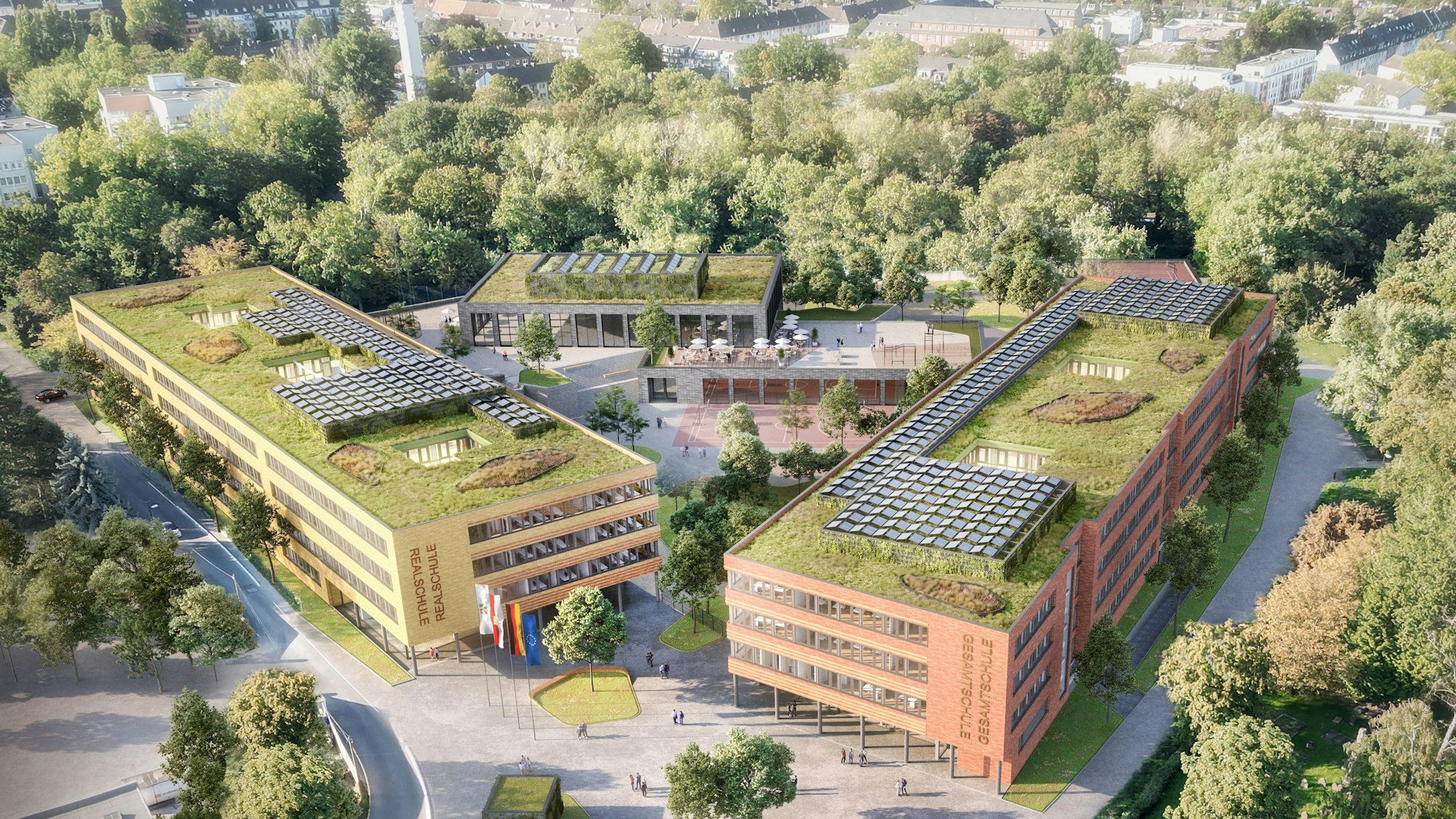 Zwei neue Schulgebäude inmitten von Grün.