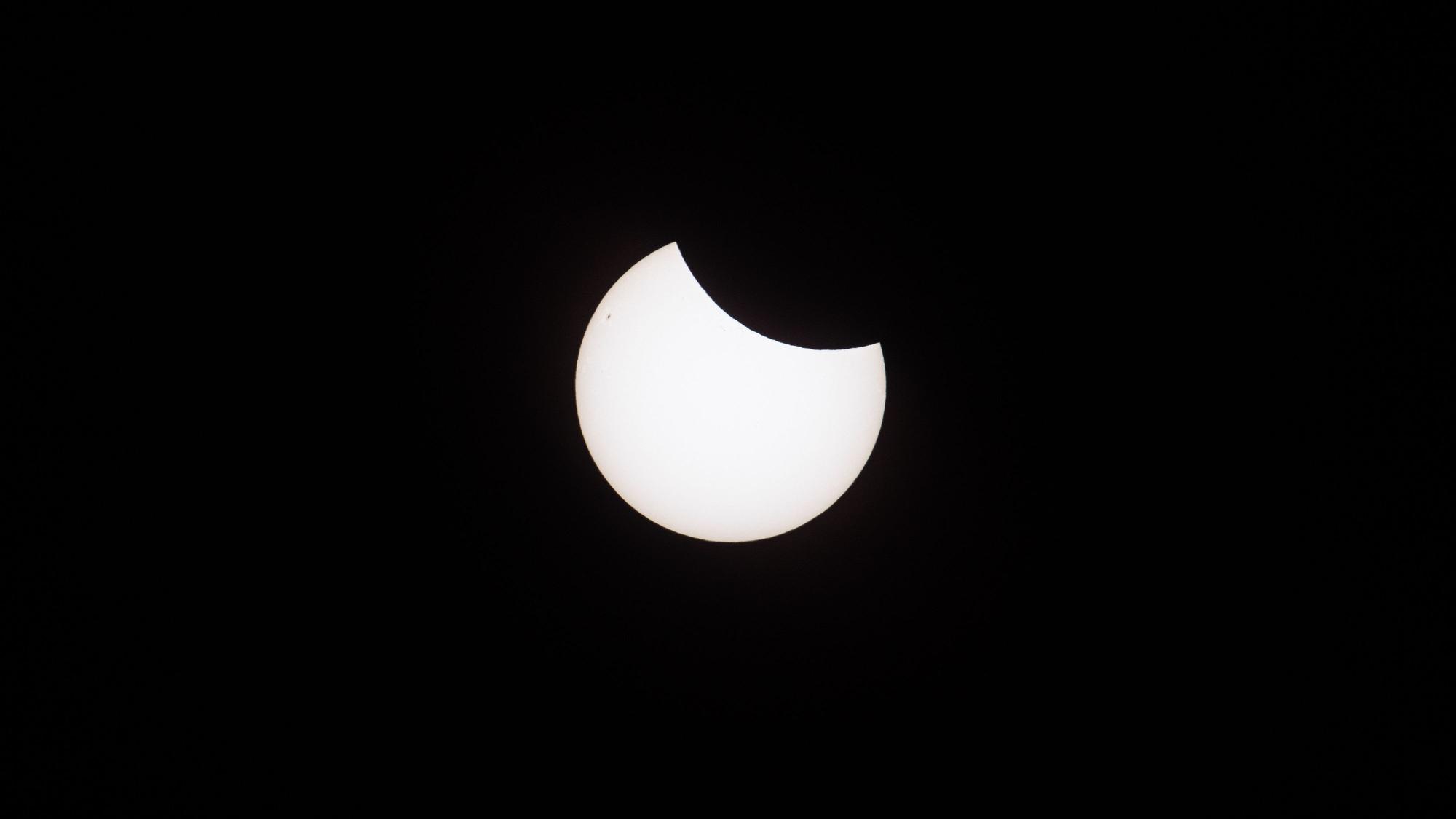 29.03.2025, Köln: Die Sonne wird bei einer partiellen Sonnenfinsternis am Rand von der Mondscheibe bedeckt. Hier in der Region beträgt die maximale Verdunkelung 20%. Aufgenommen mit 840mm Brennweite und einem Sonnenfilter. Foto: Matthias Heinekamp
