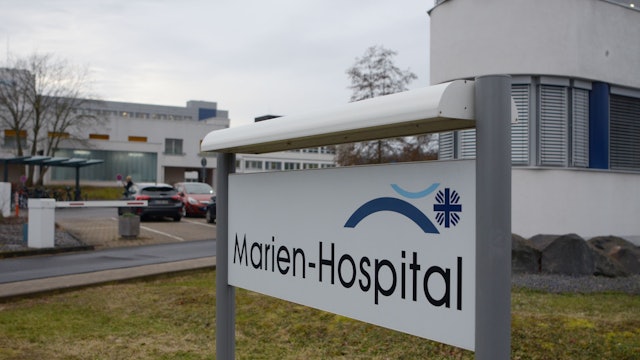 Das Bild zeigt die Einfahrt zum Krankenhaus und ein Schild mit der Auffahrt „Marien-Hospital“.