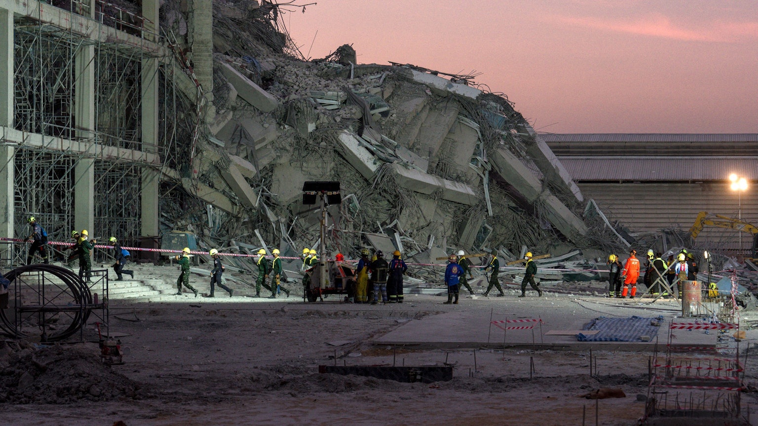 Rescue teams operate at a construction site where a building collapsed in Bangkok on March 28, 2025, following an earthquake. A powerful earthquake killed more than 20 people across Myanmar and Thailand on March 28, toppling buildings and bridges and trapping over 80 workers in an under-construction skyscraper in Bangkok. (Photo by Chanakarn Laosarakham / AFP)