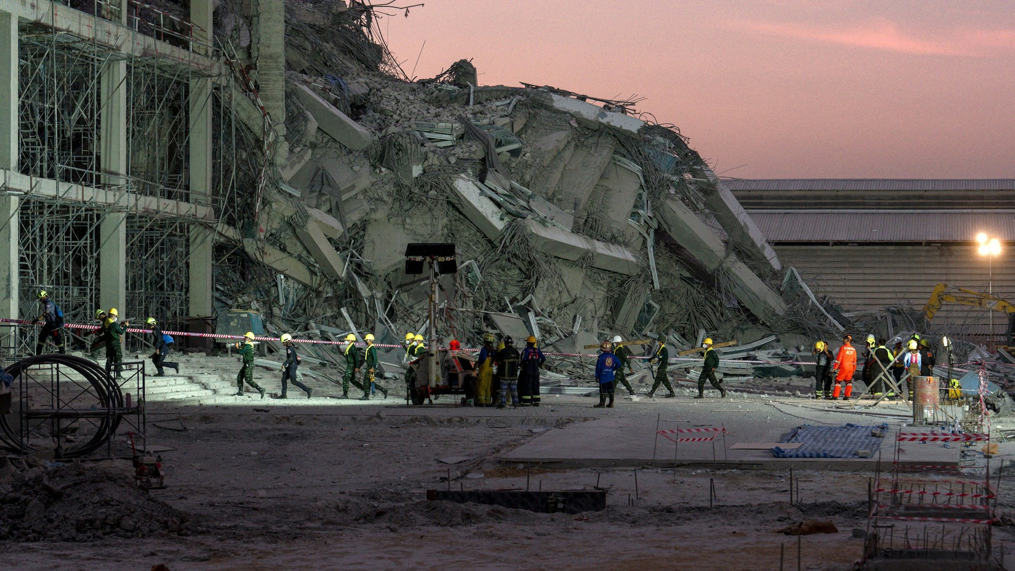 Rescue teams operate at a construction site where a building collapsed in Bangkok on March 28, 2025, following an earthquake. A powerful earthquake killed more than 20 people across Myanmar and Thailand on March 28, toppling buildings and bridges and trapping over 80 workers in an under-construction skyscraper in Bangkok. (Photo by Chanakarn Laosarakham / AFP)