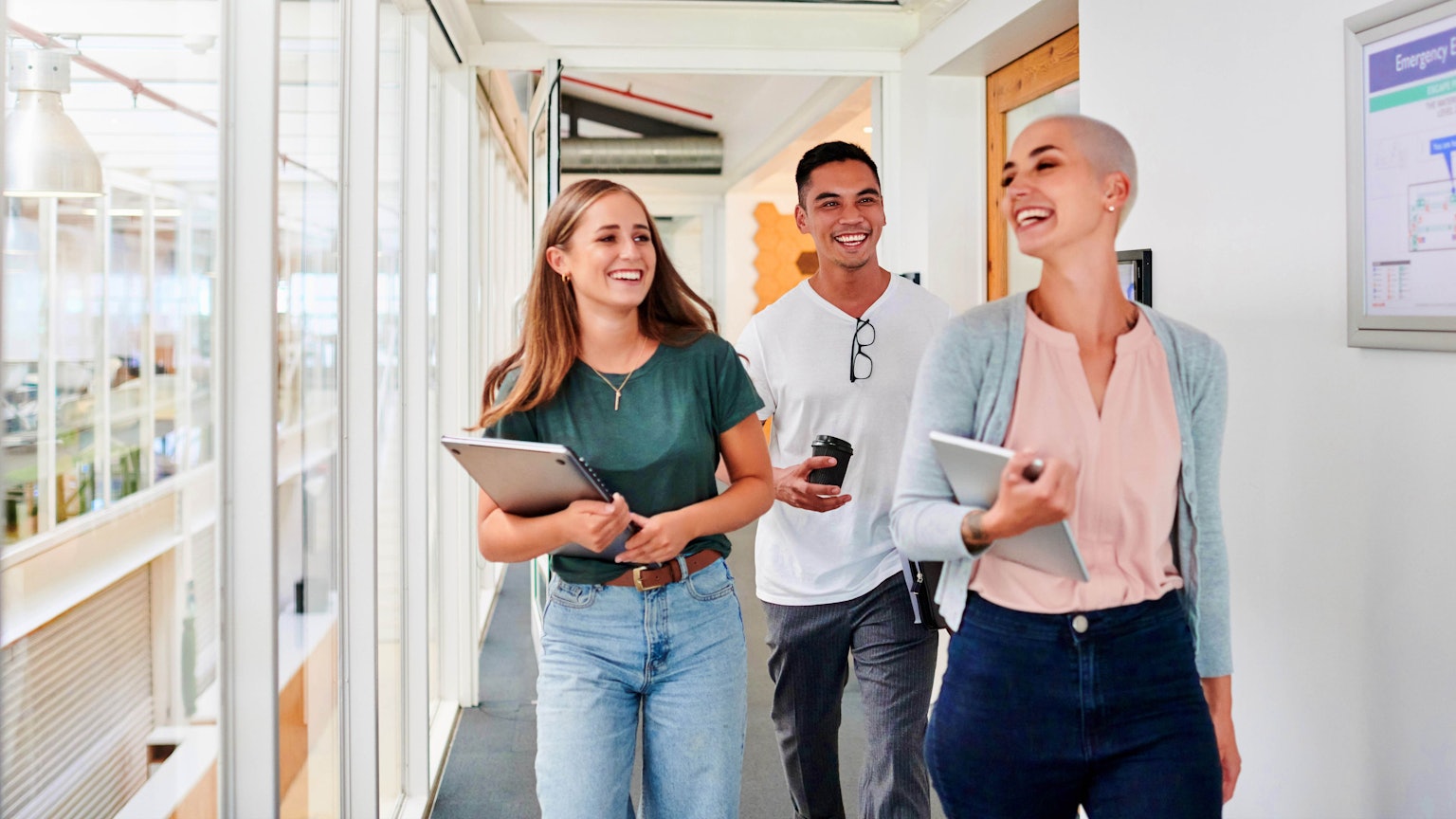 Junge Menschen gehen durch einen Korridor.