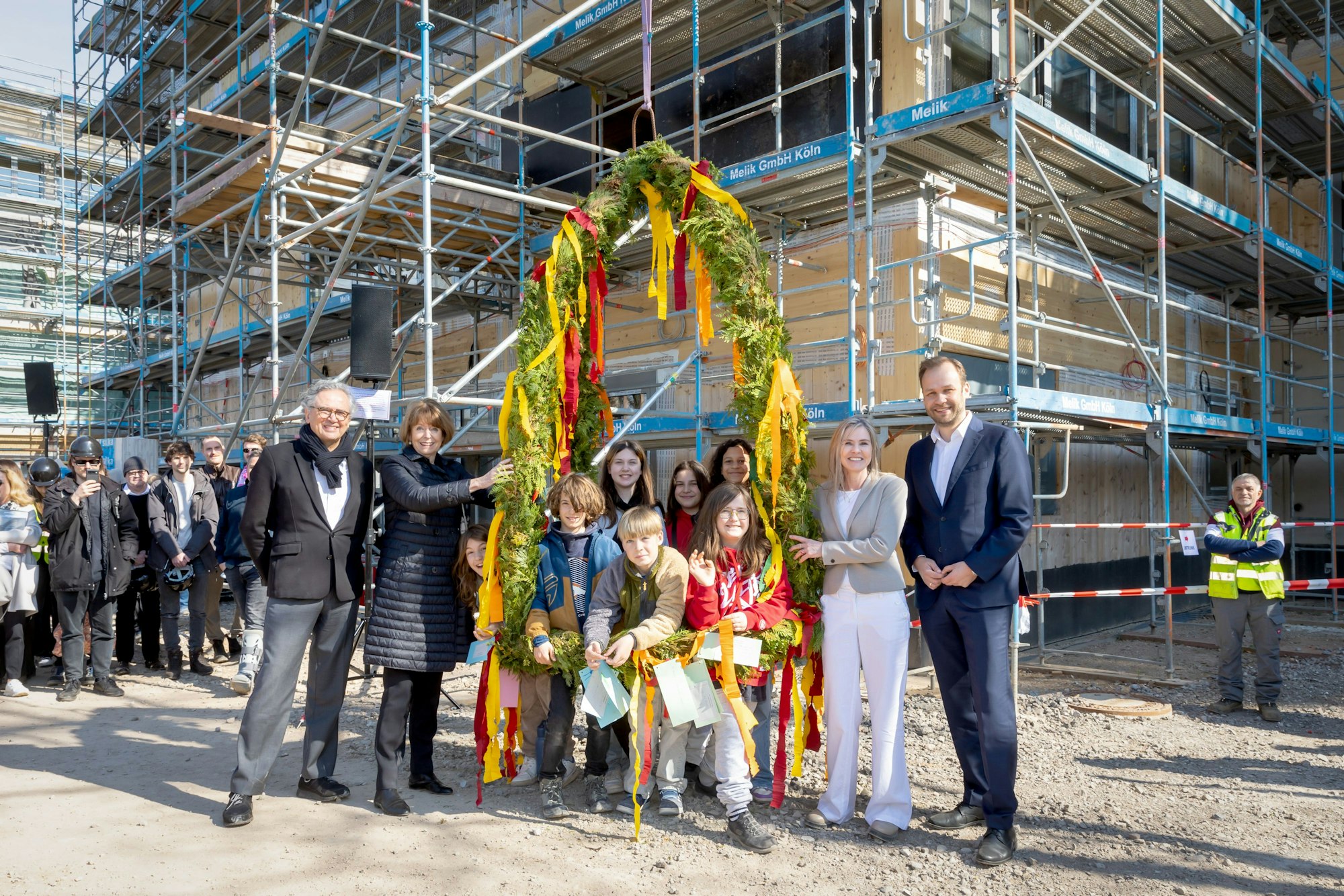 Feiern Richtfest: (v.l.) Architekt Juan Pablo Molestina, OB Henriette Reker, die Kinder der Gesamtschule Ossendorf mit Direktorin Birgit Specht und Schuldezernent Robert Voigtsberger.