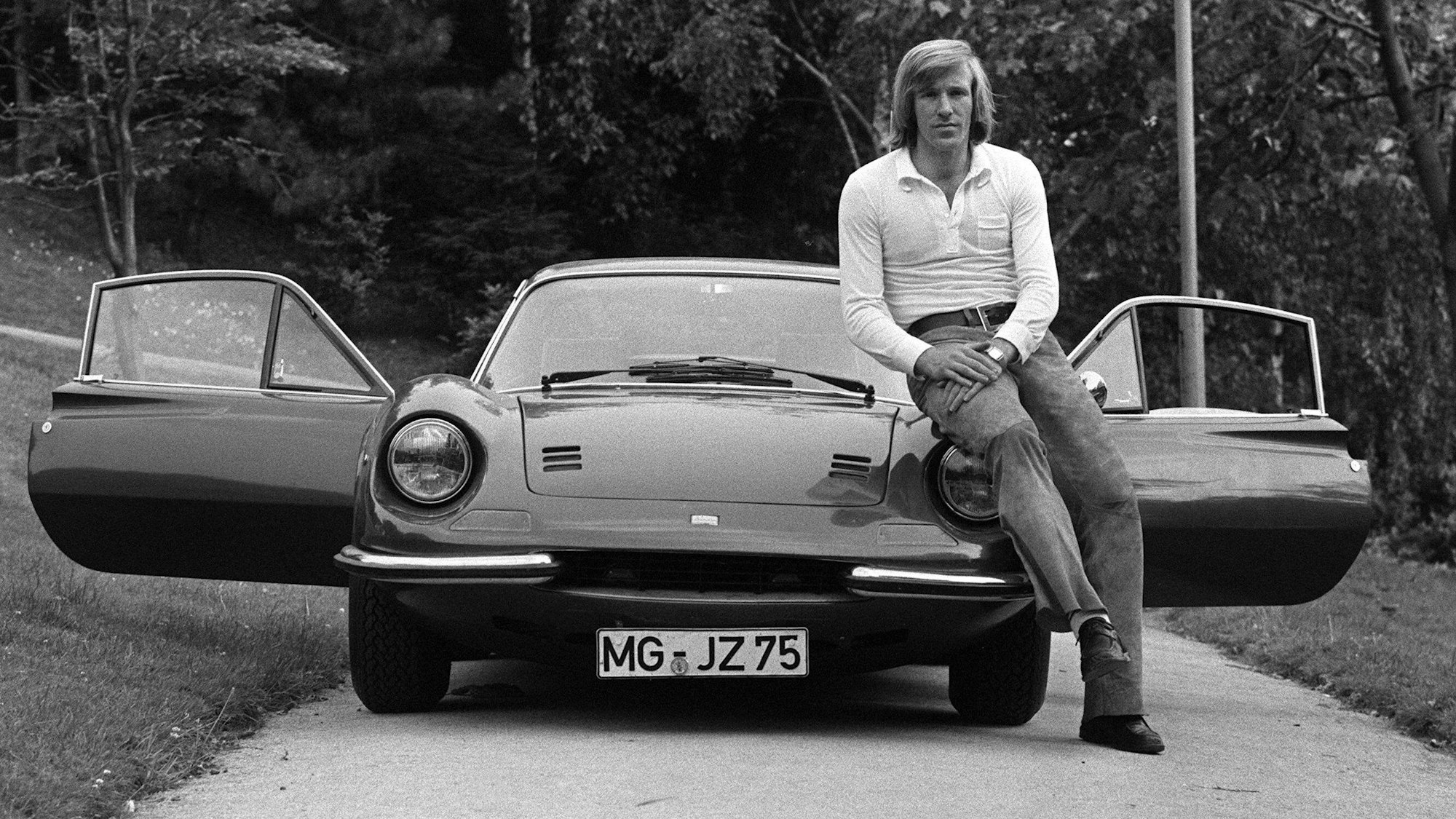 Das Bild zeigt Günther, den ersten Popstar des deutschen Fußballs, wie er lässig an der Motorhaube seines Sportwagens lehnt.