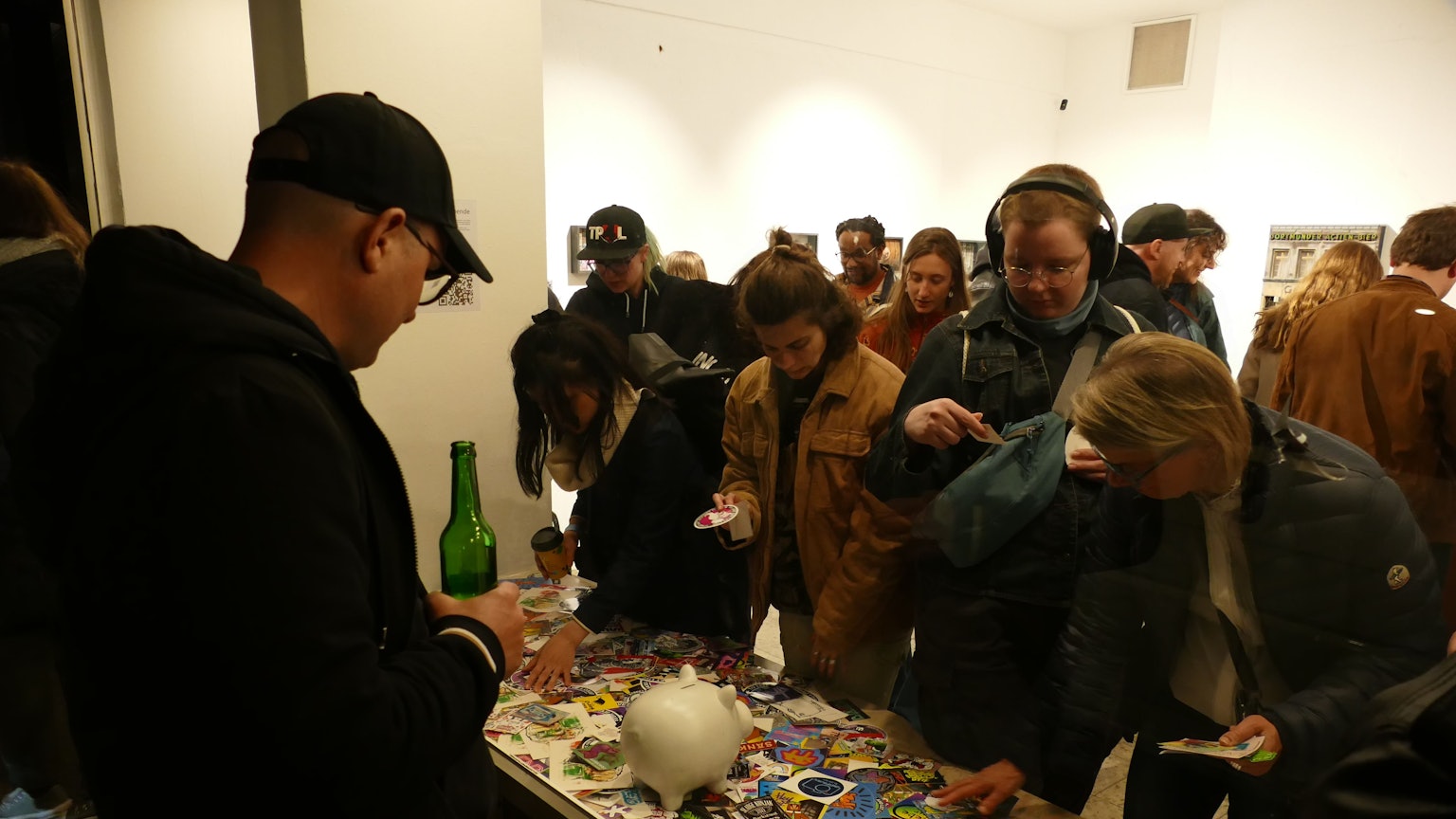 Menschen schauen anderen Menschen durchs Schaufenster beim Aussuchen von Aufklebern zu.