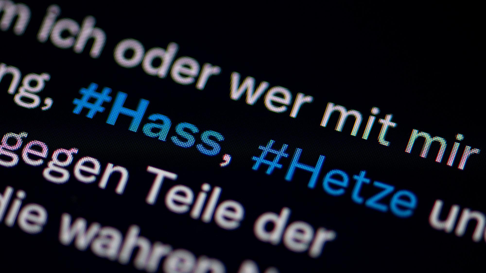 Auf dem Bildschirm eines Smartphones sieht man die Hashtags Hass und Hetze in einem Twitter-Post +++ dpa-Bildfunk +++