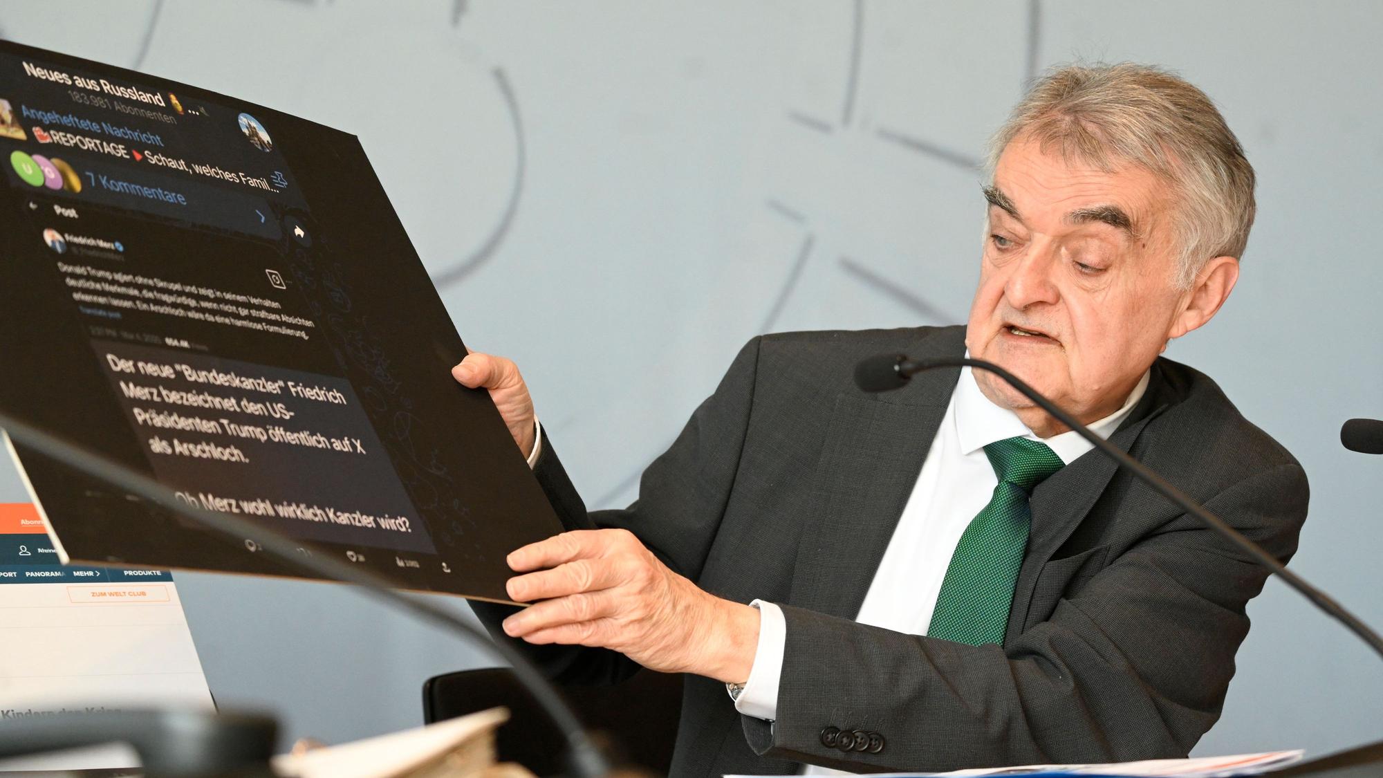 Herbert Reul(CDU), Innenminister von Nordrhein-Westfalen, zeigt eine Tafel mit Fake-Nachrichten aus dem Internet bei der Vorstellung des Verfassungsschutzbericht 2024 des Landes.
