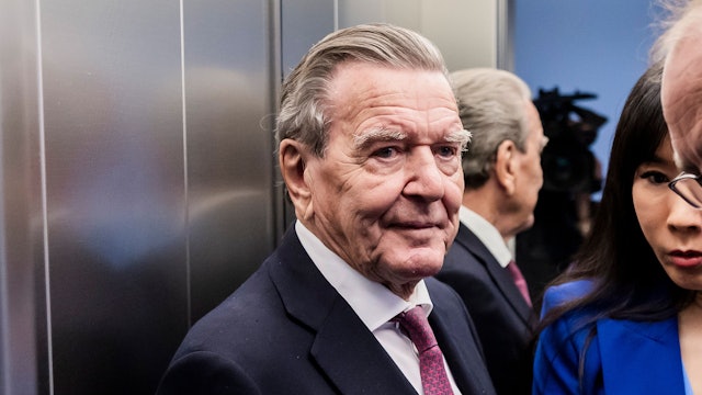 Altkanzler Gerhard Schröder (SPD, l), und seine Ehefrau Soyeon Schröder-Kim (M) stehen im Oberverwaltungsgericht (OVG) Berlin-Brandenburg nach der mündlichen Verhandlung im Prozess um den Verlust seines Büros im Bundestag in einem Aufzug.