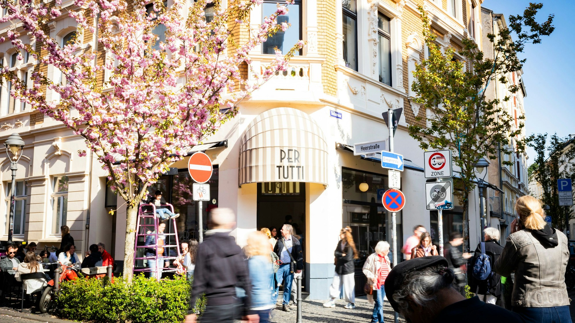 Café an der Ecke Heerstraße mit blühenden japanischen Kirschbäumen.